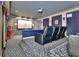 A luxury home theater with tiered seating, projector, and popcorn machine for the ultimate entertainment experience at 183 Mcgregor Rd, Deland, FL 32720