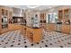 Modern kitchen with black countertops, stainless steel appliances, custom cabinets, tile flooring and center island with wine rack at 183 Mcgregor Rd, Deland, FL 32720