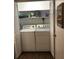 Convenient laundry closet featuring a full-size washer and dryer, with shelving for organized storage at 183 Mcgregor Rd, Deland, FL 32720