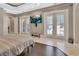 Bright main bedroom with shuttered doors leading to the outdoors and a decorative tray ceiling at 183 Mcgregor Rd, Deland, FL 32720
