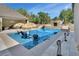 Custom backyard swimming pool with chairs in the water and sun umbrellas at 183 Mcgregor Rd, Deland, FL 32720