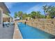 Custom pool featuring a bridge, rock wall grotto, and outdoor seating area at 183 Mcgregor Rd, Deland, FL 32720