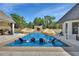 Backyard swimming pool with chairs in the water and tiki umbrellas at 183 Mcgregor Rd, Deland, FL 32720