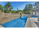 Backyard lap pool with a bridge leading to a rock grotto feature at 183 Mcgregor Rd, Deland, FL 32720