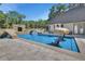 Backyard pool with chairs in the water and bridge to rock grotto at 183 Mcgregor Rd, Deland, FL 32720