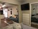Studio apartment with a kitchenette, seating area, built in shelving, closet, and TV at 183 Mcgregor Rd, Deland, FL 32720