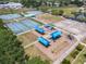 An aerial view of a community park featuring tennis courts, a playground, and a basketball court at 1860 Forough Cir, Port Orange, FL 32128