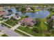 Stunning aerial view of home overlooking a lake with a fountain and well-manicured landscaping at 1860 Forough Cir, Port Orange, FL 32128