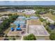 An aerial view of a park featuring tennis courts, a playground, a building, and a basketball court at 1860 Forough Cir, Port Orange, FL 32128