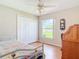 Bright bedroom with closet, ceiling fan, laminate floors, and natural light at 1860 Forough Cir, Port Orange, FL 32128