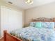 Comfortable bedroom featuring a nautical themed quilt, ceiling fan, and closet space at 1860 Forough Cir, Port Orange, FL 32128