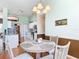Cozy dining area with modern table, seating for four, and views into the kitchen area at 1860 Forough Cir, Port Orange, FL 32128