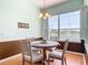 Bright dining area features a round table, four chairs, and a window overlooking the lake at 1860 Forough Cir, Port Orange, FL 32128