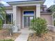 Close-up view of the front entrance with decorative glass doors and landscaped yard at 1860 Forough Cir, Port Orange, FL 32128