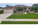 Charming home with a well-manicured lawn, a convenient two-car garage, and lush landscaping at 1860 Forough Cir, Port Orange, FL 32128