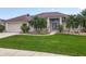 Lovely home featuring a well-maintained lawn, beautiful landscaping, and a two-car garage at 1860 Forough Cir, Port Orange, FL 32128