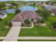 Beautiful front exterior of home with manicured lawn, trees and shrubbery at 1860 Forough Cir, Port Orange, FL 32128
