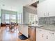 Open concept kitchen offers stainless appliances and granite countertops next to dining area at 1860 Forough Cir, Port Orange, FL 32128
