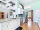 Open kitchen with stainless steel appliances, granite countertops, and modern white cabinets at 1860 Forough Cir, Port Orange, FL 32128