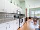 Bright kitchen adjacent to a dining area, equipped with modern appliances and ample cabinet space at 1860 Forough Cir, Port Orange, FL 32128