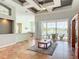 Open-concept living area with tray ceiling, patio view, tile floors, and a built-in cabinet, ideal for entertaining guests at 1860 Forough Cir, Port Orange, FL 32128