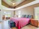 Tranquil main bedroom with a ceiling fan, lake view, and seating area at 1860 Forough Cir, Port Orange, FL 32128