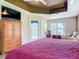 Cozy main bedroom features an ensuite bath, access to the pool area, and lake views at 1860 Forough Cir, Port Orange, FL 32128