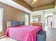 Spacious main bedroom boasts tray ceilings, ensuite bathroom access, and natural light at 1860 Forough Cir, Port Orange, FL 32128