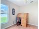 Bright office space features laminate wood floors, a clock, and backyard views at 1860 Forough Cir, Port Orange, FL 32128