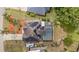 An aerial view of a home with solar panels, a screened pool, and lush landscaping at 1862 Shelby Ter, Deltona, FL 32725