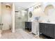 Bright bathroom features dual vanities, a glass-enclosed shower, and neutral tile flooring at 1862 Shelby Ter, Deltona, FL 32725
