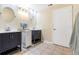 Bright bathroom features dual vanities, modern fixtures, and neutral tile flooring at 1862 Shelby Ter, Deltona, FL 32725
