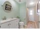 A well-lit bathroom includes a vanity with storage and a shower with an patterned curtain at 1862 Shelby Ter, Deltona, FL 32725