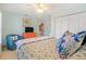 Inviting bedroom with a bright dresser, ceiling fan, and cozy seating area at 1862 Shelby Ter, Deltona, FL 32725