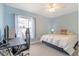 Cozy bedroom featuring a work desk, ceiling fan, and soft natural light at 1862 Shelby Ter, Deltona, FL 32725