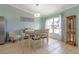 Bright dining room with a large window, comfortable seating, and stylish decor at 1862 Shelby Ter, Deltona, FL 32725