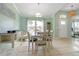 Sunlit dining room with tiled flooring, stylish decor, and a large window at 1862 Shelby Ter, Deltona, FL 32725