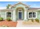 Welcoming front entrance featuring decorative columns, arched windows, and a blue front door at 1862 Shelby Ter, Deltona, FL 32725