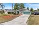 Charming front exterior of a well-maintained home with a lush lawn and a driveway at 1862 Shelby Ter, Deltona, FL 32725