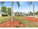 Charming single Gathering home with a green lawn, mulch, palm trees, and driveway leading to the garage at 1862 Shelby Ter, Deltona, FL 32725