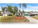 Charming one-story home featuring a lush green lawn with palm trees and a long driveway leading to the garage at 1862 Shelby Ter, Deltona, FL 32725