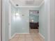 The hallway has tile flooring and light walls, leading into a living area with a comfortable couch at 1862 Shelby Ter, Deltona, FL 32725