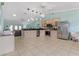 Open-concept kitchen with stainless steel appliances, light wood cabinets and tiled flooring at 1862 Shelby Ter, Deltona, FL 32725