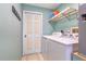 This functional laundry room has tile floors and includes a washer, dryer, and shelving for storage at 1862 Shelby Ter, Deltona, FL 32725