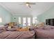 Spacious living room with plush seating and doors that lead to the pool area at 1862 Shelby Ter, Deltona, FL 32725