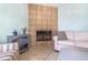 Cozy living room featuring a tiled fireplace, comfortable seating, and soft, neutral decor at 1862 Shelby Ter, Deltona, FL 32725