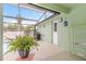 The outdoor patio with a potted fern, exterior door and access to the pool at 1862 Shelby Ter, Deltona, FL 32725