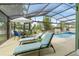Enclosed pool area featuring a lounge, dining table, and views of the waterfront at 1862 Shelby Ter, Deltona, FL 32725