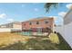 Backyard features an in-ground pool, patio, fencing, and a two-story home at 193 Fish Hawk Dr, Winter Haven, FL 33884
