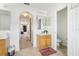 Bathroom features a sink with wood cabinets, arched hallway to bedroom, and tiled floors at 193 Fish Hawk Dr, Winter Haven, FL 33884